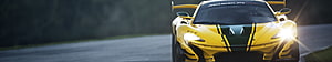 Yellow McLaren 720S GT3 race car with black racing stripes on a track HD wallpaper