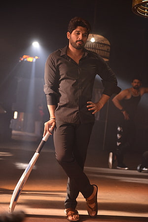 Allu Arjun in Black Shirt Holding Cricket Bat in Dimly Lit Gym Setting HD phone wallpaper