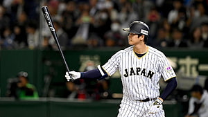 Japanese Baseball Player Holding Bat in Pinstripe Uniform HD wallpaper