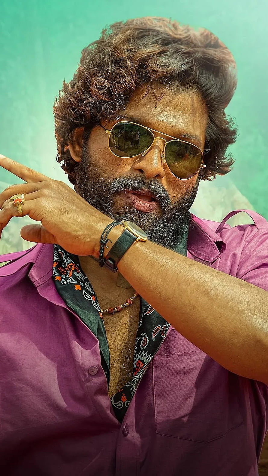 Allu Arjun as Pushpa in a purple shirt with aviator sunglasses and a bold hand gesture HD phone wallpaper