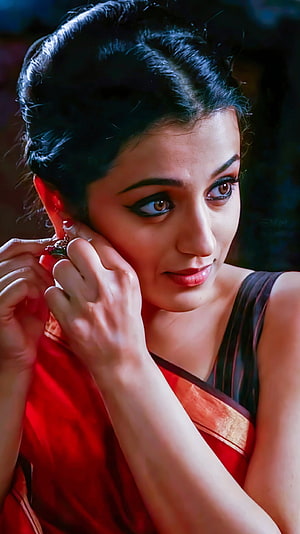 Vibha Chaudhari in a red saree adjusting her earrings with a soft smile HD phone wallpaper