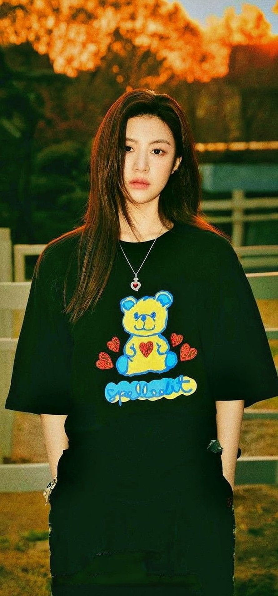 High quality portrait of a young woman wearing a black t-shirt with a colorful teddy bear graphic and heart necklace, Go Yoon Jung HD phone wallpaper