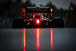 Aston Martin Formula 1 Car Rear View With Glowing Red Brake Lights On Wet Track HD wallpaper