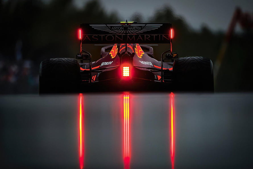 Aston Martin Formula 1 Car Rear View With Glowing Red Brake Lights On Wet Track HD wallpaper