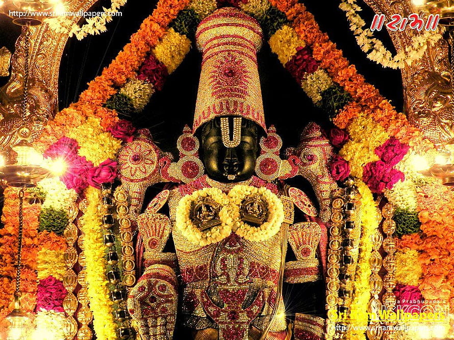 Lord Venkateswara adorned in gold jewelry and vibrant flower garlands at Tirumala temple HD wallpaper