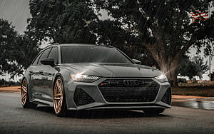 Audi RS6 Avant C8 in Gray with Bronze Wheels on a Rainy Road HD wallpaper