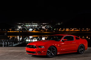Red Ford Mustang GT Coupe Parked at Night by Waterfront with Stadium Lights HD wallpaper