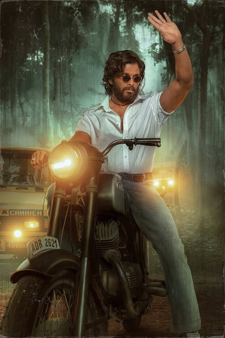 Pushpa Raj on a vintage motorcycle in a misty forest with a raised hand and glowing headlight HD phone wallpaper