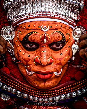 Traditional Kathakali Dance Makeup Portrait with Intricate Silver Jewelry and Crown HD phone wallpaper