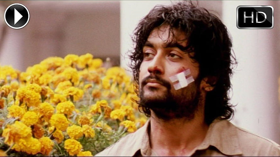 Surya Son of Krishnan Movie Still Featuring Marigold Flowers and Bandaged Cheek HD wallpaper