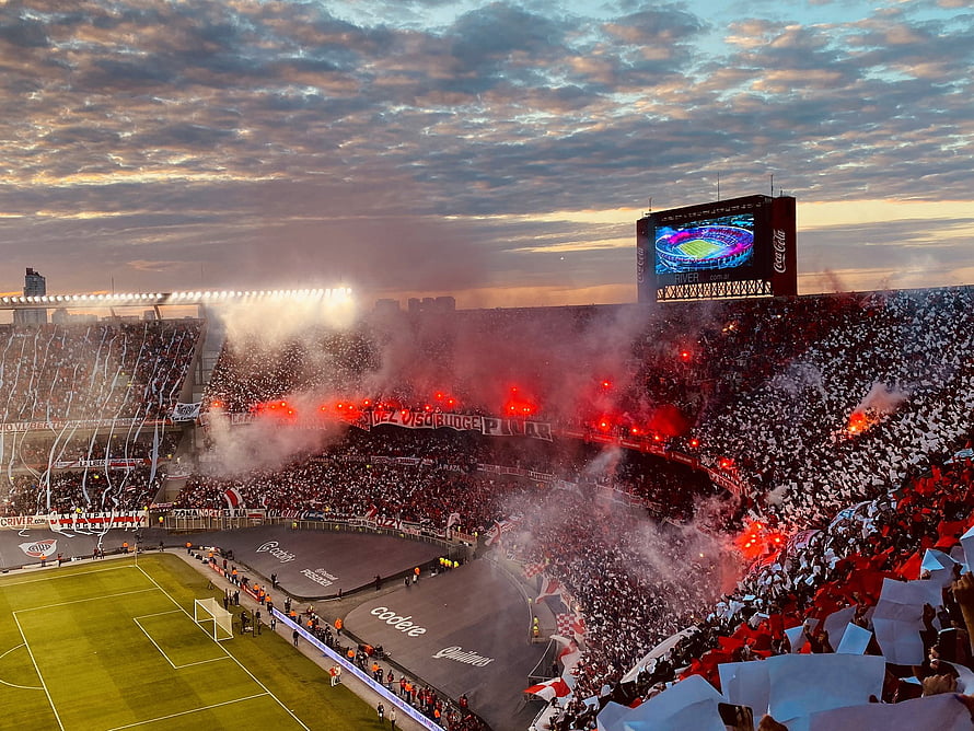 River Plate Fans Celebrating with Red Flares and Smoke at Estadio Monumental Stadium HD wallpaper