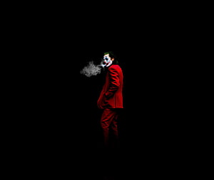Joker in Red Suit Smoking Against Black Background HD wallpaper