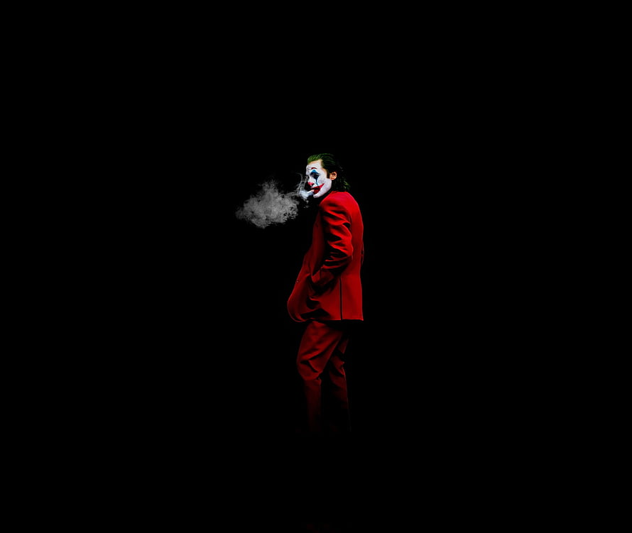 Joker in Red Suit Smoking Against Black Background HD wallpaper