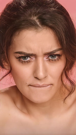 Hansika Motwani Intense Close-Up Portrait with Fierce Expression on Pink Background HD phone wallpaper