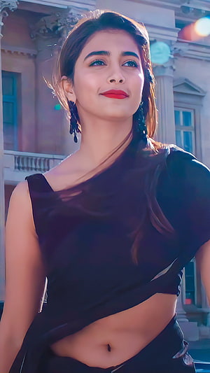 Pooja Hegde in a stylish black saree with a confident smile and elegant earrings HD phone wallpaper