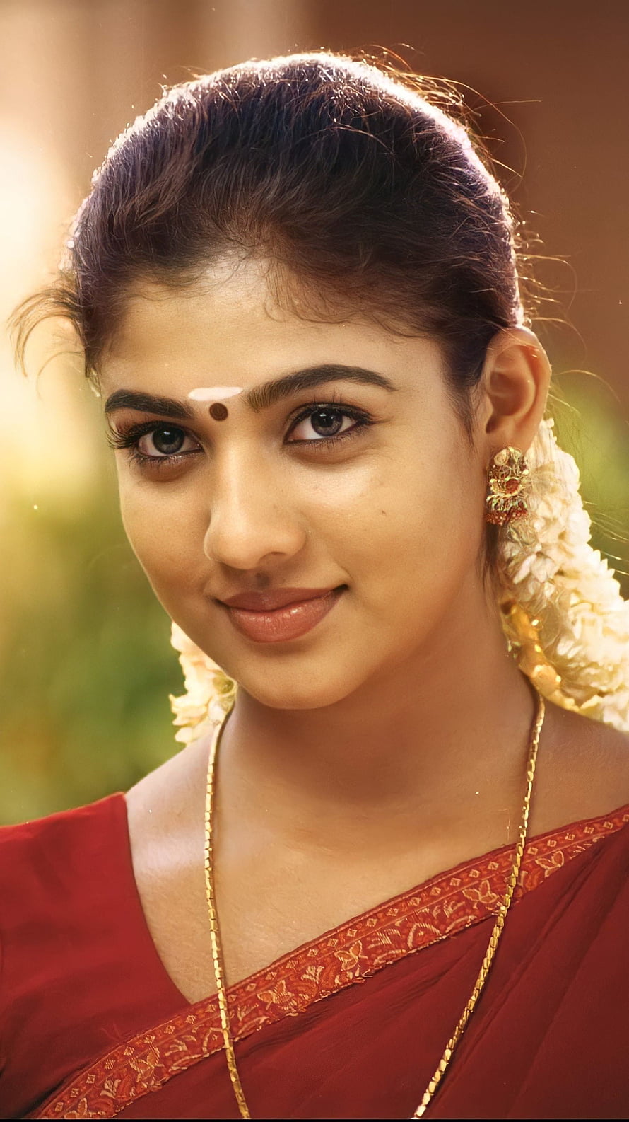 Portrait of Indian Actress Pooja Hegde Wearing a Red Saree with Traditional Jewelry and Flowers HD phone wallpaper