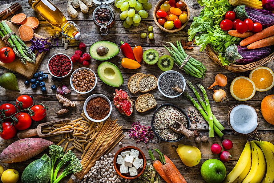 Vibrant Plant Based Nutrition Spread With Fresh Vegetables Fruits Grains And Nuts On Rustic Wood HD wallpaper
