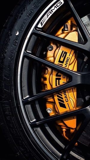 Close-up of Mercedes-AMG S-Class Ceramic Brake Caliper and Black Multi-Spoke Alloy Wheel HD phone wallpaper