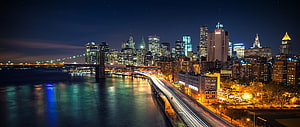 Chicago skyline at night with light trails along the river and illuminated skyscrapers HD wallpaper