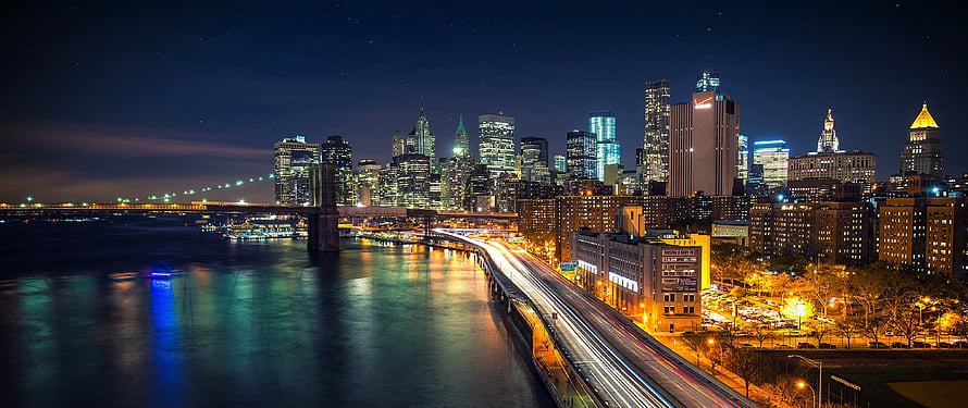 Chicago skyline at night with light trails along the river and illuminated skyscrapers HD wallpaper