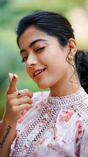 Pooja Hegde smiling portrait wearing a pink floral dress with intricate lace details and elegant jewelry HD phone wallpaper