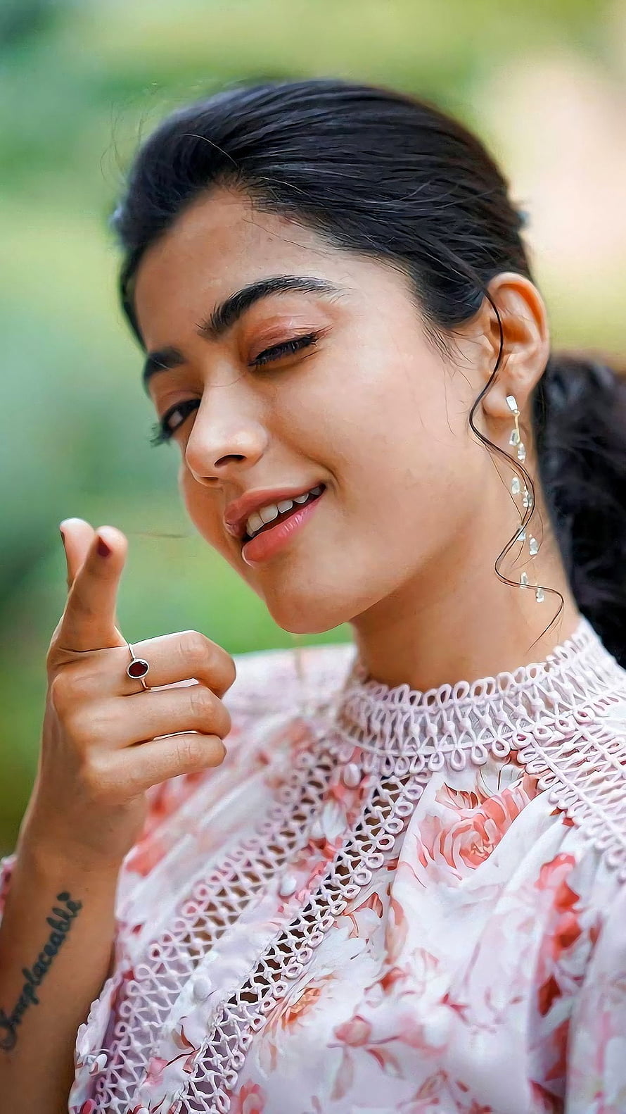 Pooja Hegde smiling portrait wearing a pink floral dress with intricate lace details and elegant jewelry HD phone wallpaper