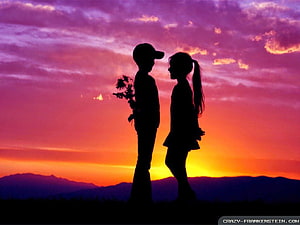Silhouette of a Boy Giving Flowers to a Girl at Sunset HD wallpaper