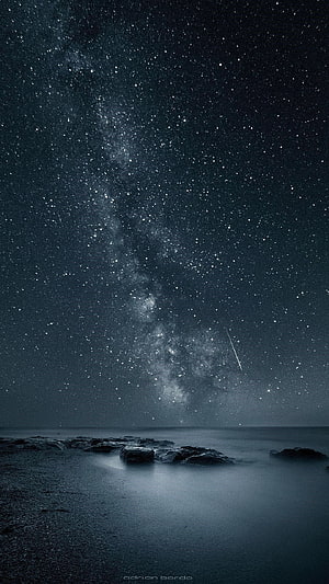 Milky Way Galaxy Over Calm Ocean With Rocks And Shooting Star HD phone wallpaper