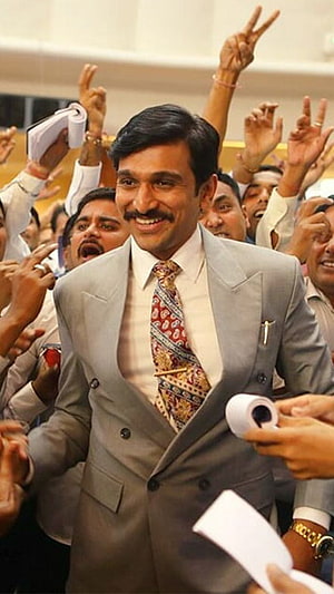 Allu Arjun in a grey suit smiling amidst a crowd of cheering fans holding papers HD phone wallpaper