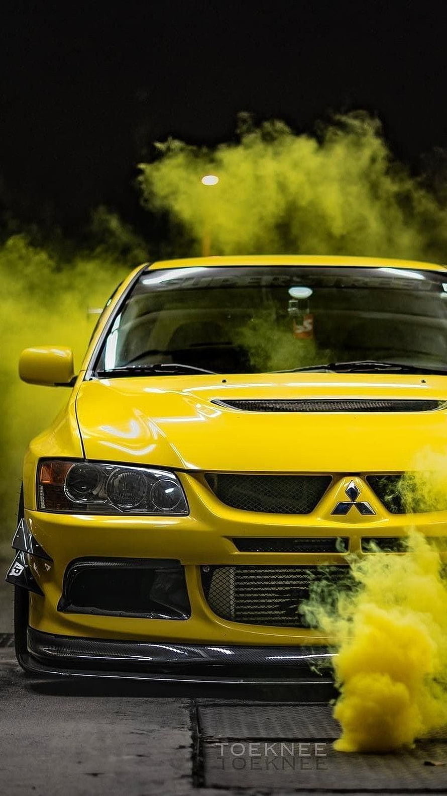 Yellow Mitsubishi Lancer Evolution with Yellow Smoke at Night HD phone wallpaper