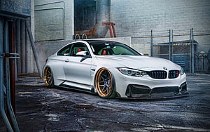 White BMW M4 F82 Coupe with Bronze Wheels in Industrial Setting HD wallpaper