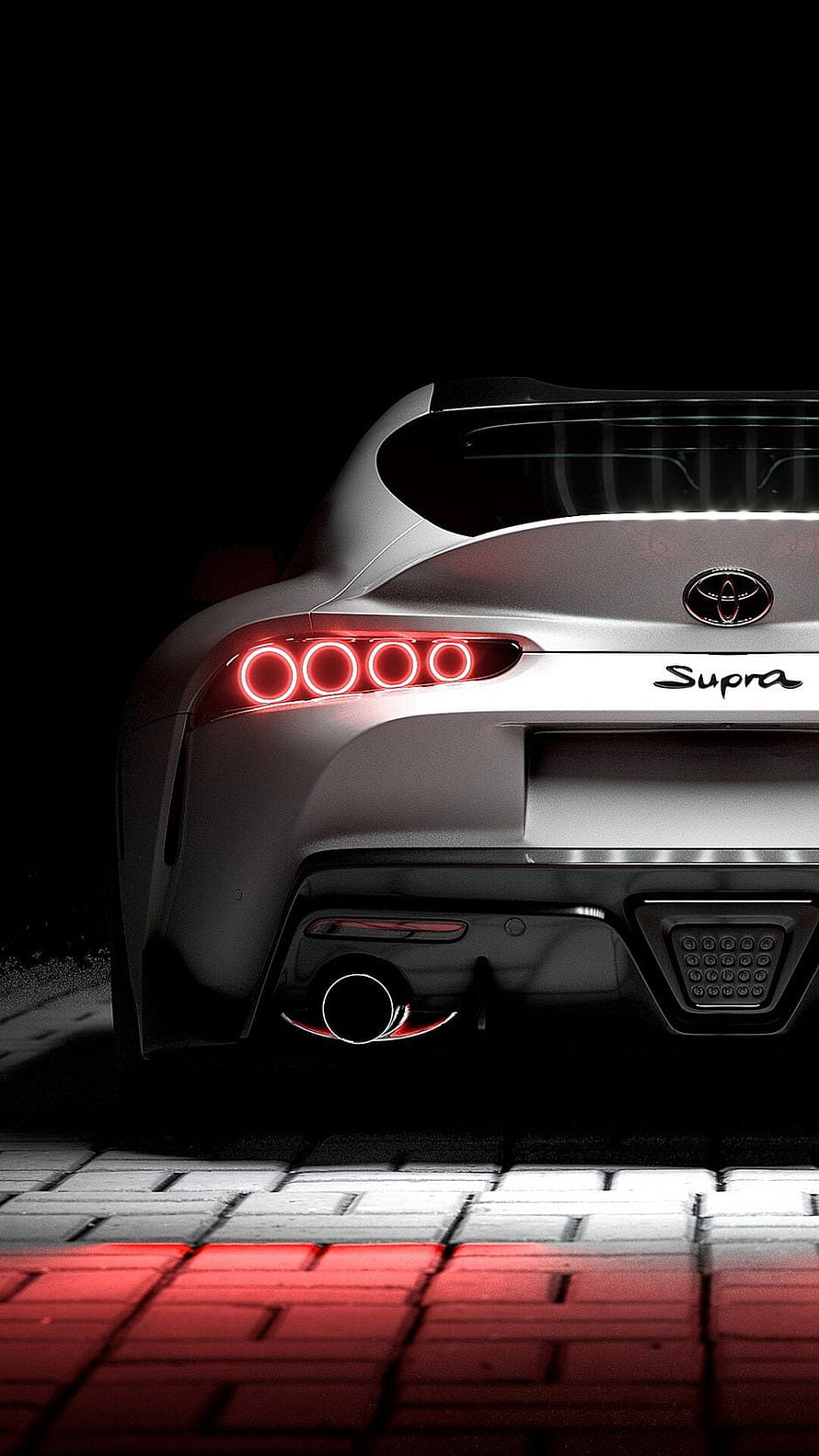 Rear View of Silver Toyota Supra with Glowing Red Taillights on Dark Pavement HD phone wallpaper