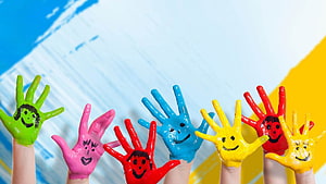 Colorful Painted Children's Hands with Smiley Faces on Bright Background HD wallpaper