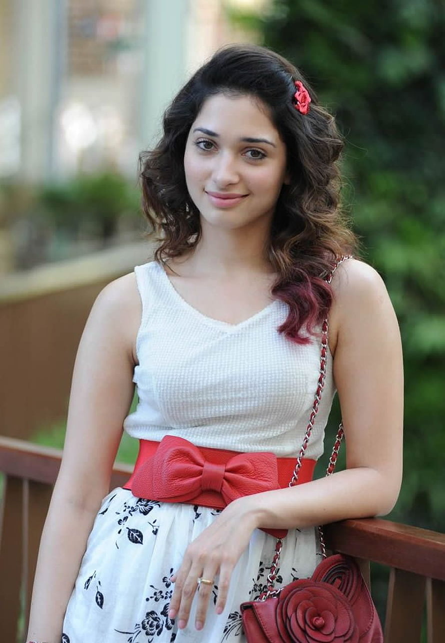 Tamanna Bhatia in a white sleeveless top with a red bow belt and floral skirt HD phone wallpaper