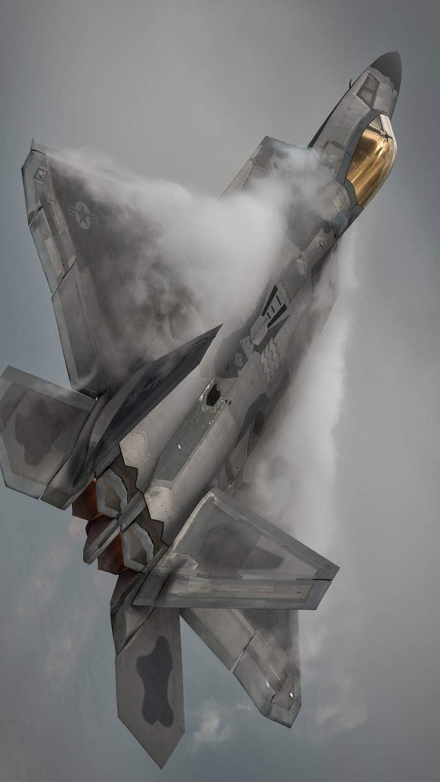 F-22 Raptor Stealth Fighter Jet Breaking Through Clouds in Dramatic Aerial Maneuver HD phone wallpaper