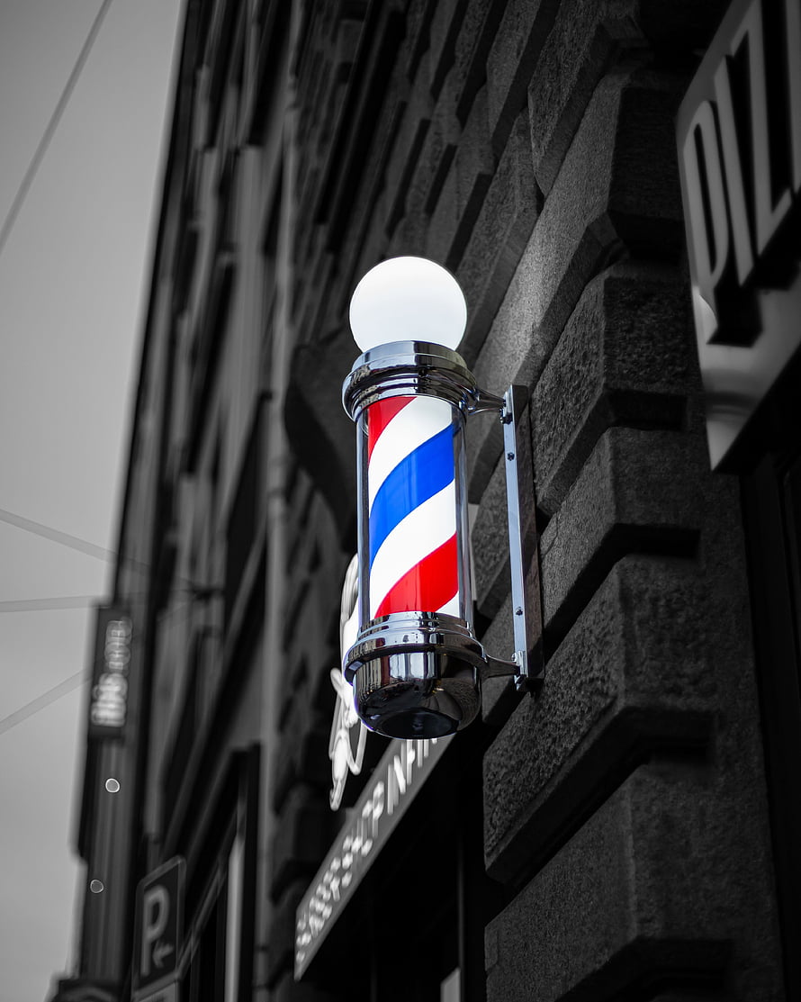 Classic Red White And Blue Barber Pole Mounted On Dark Stone Facade HD phone wallpaper