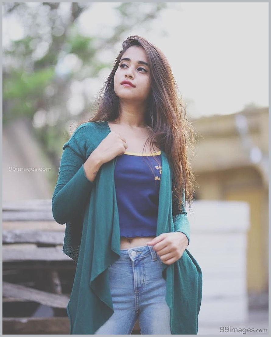 Deepthi Sunaina in a green cardigan and blue top with long hair in an outdoor portrait HD phone wallpaper