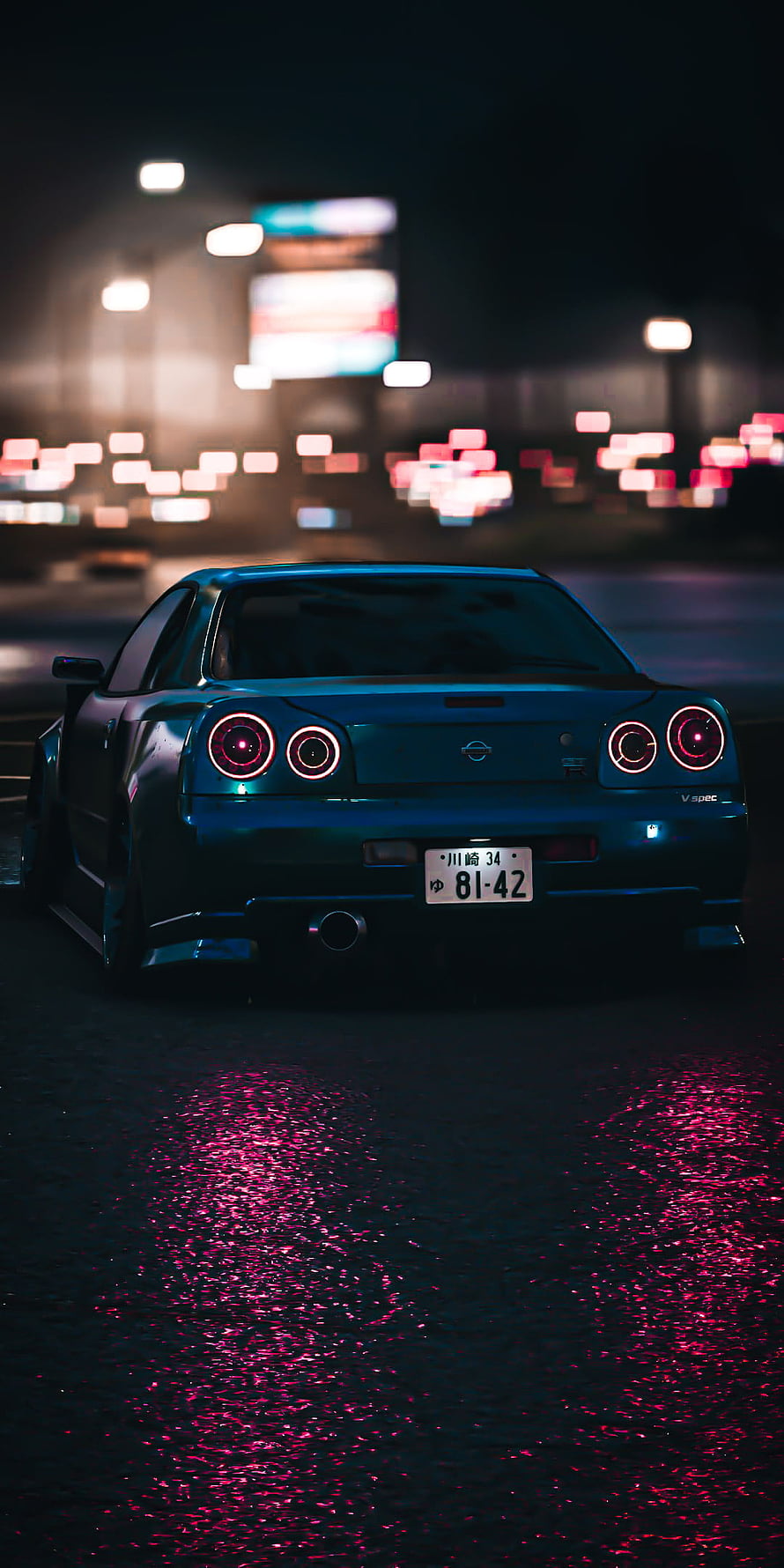 Nissan GT-R R34 Rear View at Night with Neon City Lights and Wet Asphalt Reflections HD phone wallpaper
