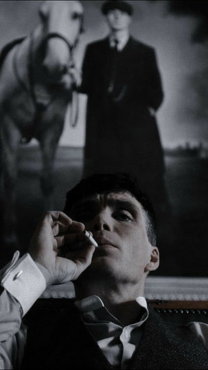 Thomas Shelby smoking cigarette with horse portrait background in black and white HD phone wallpaper