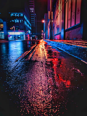 Neon City Street at Night with Wet Pavement and Colorful Light Reflections HD phone wallpaper