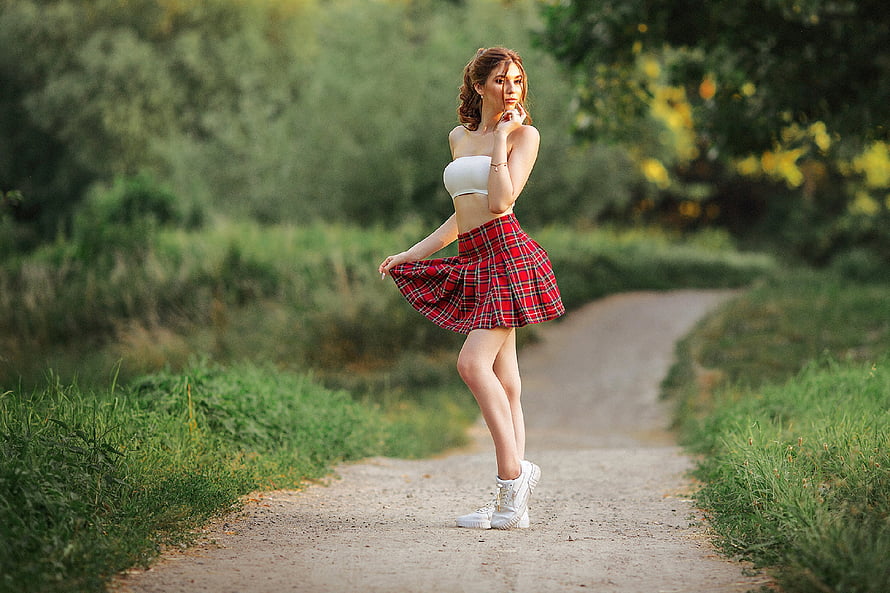 Young woman in white crop top and red plaid skirt posing on a forest path, Redhead in a Plaid Skirt, skirt, outdoors, redhead, model HD wallpaper