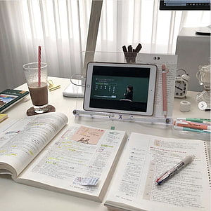 Cozy Study Desk Setup with Open Textbooks, Tablet, and Coffee HD phone wallpaper
