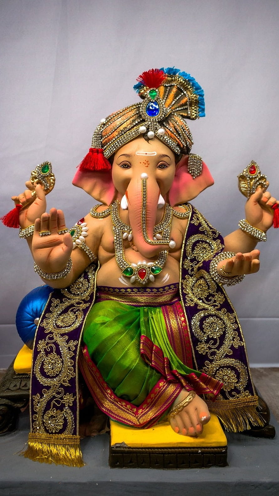 Ornate Ganesha Statue with Jeweled Crown and Purple Robe HD phone wallpaper