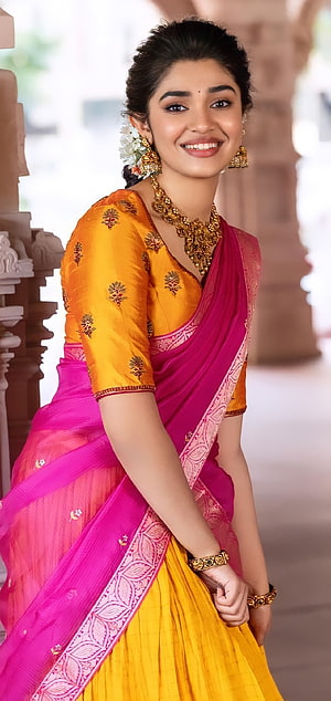 Keerthy Suresh in a vibrant yellow and pink saree with traditional gold jewelry HD phone wallpaper