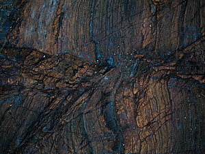 Dark Textured Rock Surface With Blue And Brown Mineral Veins HD wallpaper