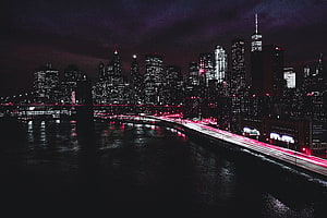 New York City Manhattan Skyline at Night with Red Light Trails on the East River HD wallpaper