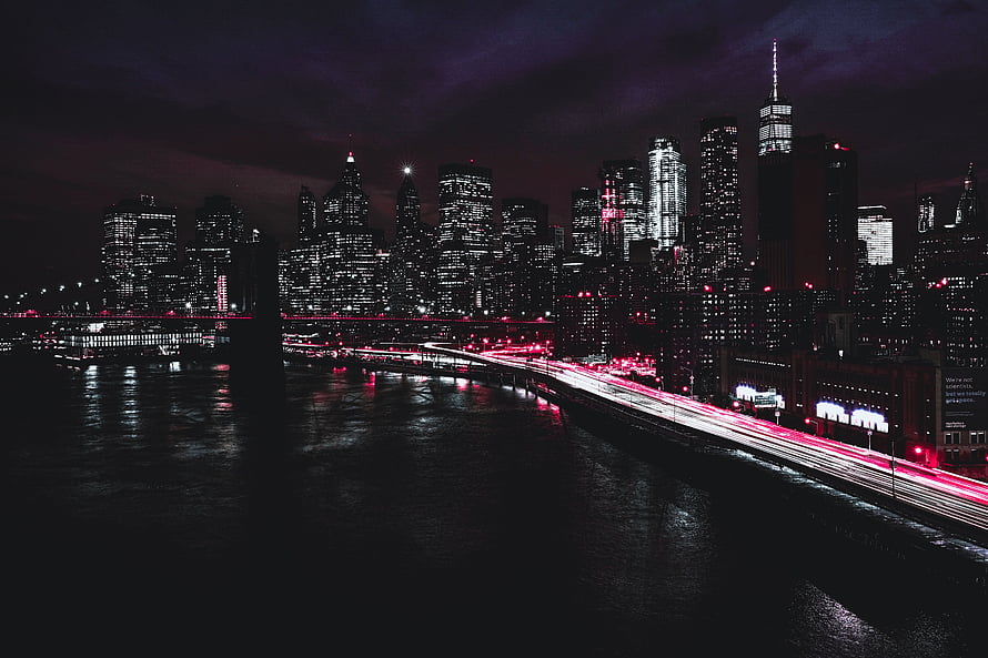 New York City Manhattan Skyline at Night with Red Light Trails on the East River HD wallpaper