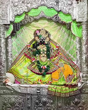 Ornate Silver Shrine of Goddess Kali with Green Silk Drapes and Floral Offerings HD phone wallpaper