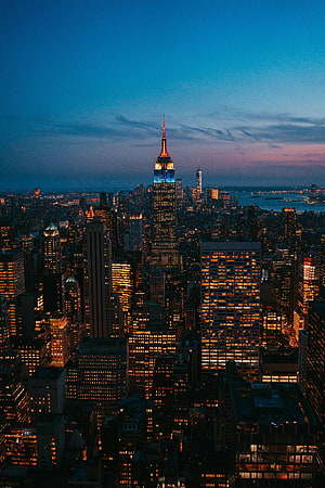 Empire State Building Illuminated at Dusk Over New York City Skyline HD phone wallpaper