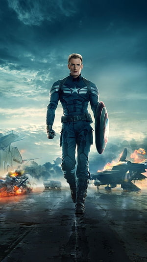 Captain America Walking on Airfield with Shield Amidst Explosions and Military Aircraft HD phone wallpaper